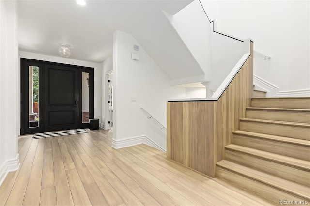 entryway with light hardwood / wood-style floors