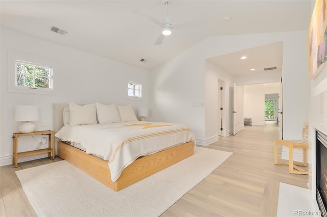 bedroom featuring vaulted ceiling, light hardwood / wood-style floors, and ceiling fan