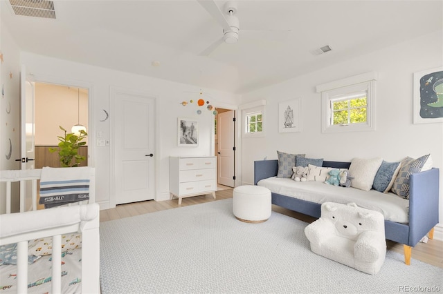 living room with ceiling fan and light wood-type flooring