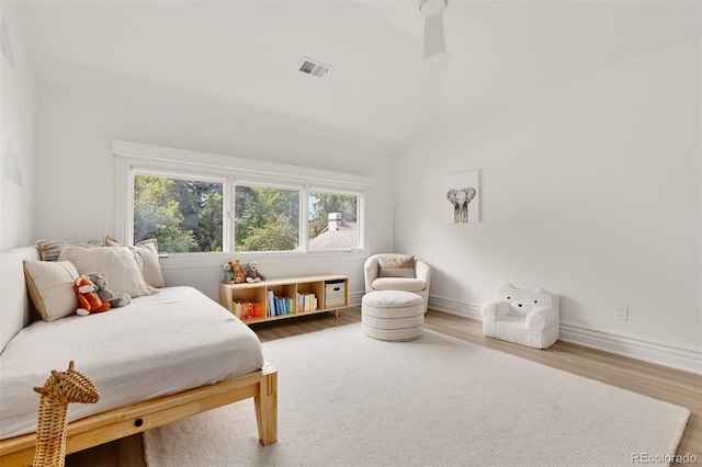 bedroom with wood-type flooring and lofted ceiling