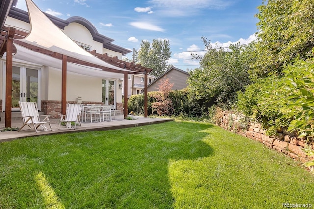 view of yard featuring a pergola, a patio, and french doors