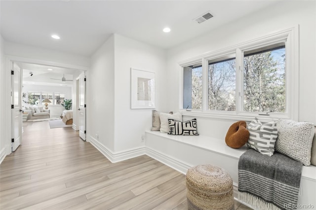 living area featuring visible vents, recessed lighting, baseboards, and light wood-style floors