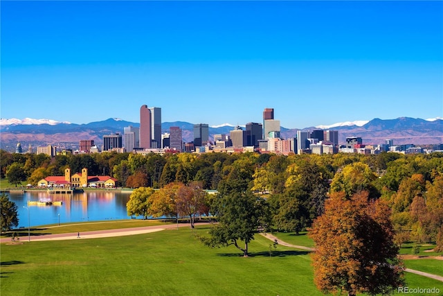 view of community with a lawn, a view of city, and a water and mountain view