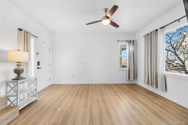 unfurnished room featuring light wood-style flooring, baseboards, and ceiling fan