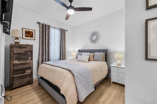 bedroom featuring light wood-type flooring and a ceiling fan