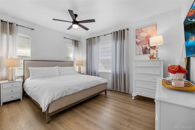 bedroom with light wood-style flooring and a ceiling fan