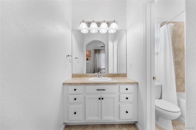 full bathroom with vanity, tile patterned floors, toilet, and shower / bath combo with shower curtain