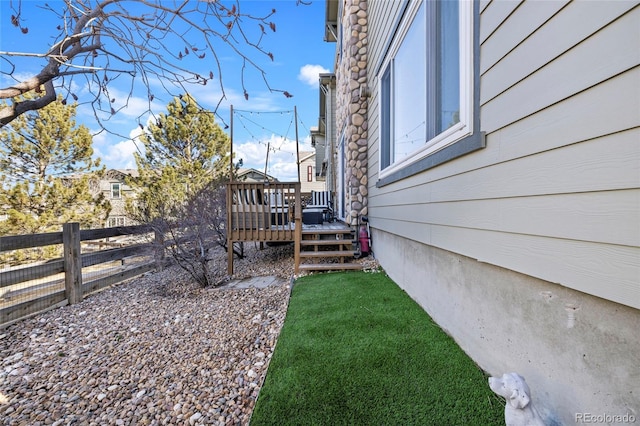 view of yard featuring fence and a wooden deck