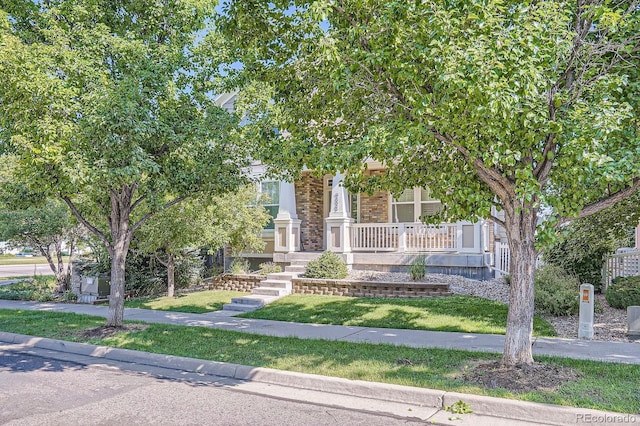9523 Gray Ct, Westminster, CO 80031 - view of property hidden behind natural elements featuring a porch and a front yard