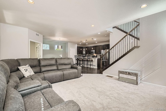 9523 Gray Ct, Westminster, CO 80031 - living area featuring recessed lighting, dark carpet, and stairway
