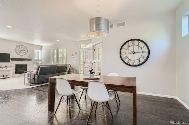 9523 Gray Ct, Westminster, CO 80031 - dining area with dark wood finished floors, a glass covered fireplace, and recessed lighting