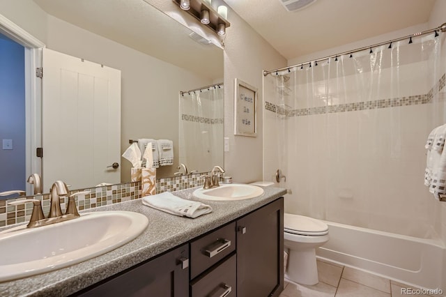 9523 Gray Ct, Westminster, CO 80031 - full bath featuring double vanity, tile patterned floors, and shower / bath combo with shower curtain