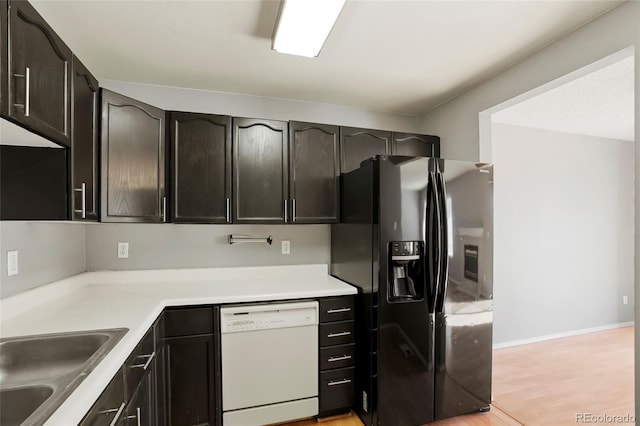 kitchen featuring sink, stainless steel fridge, dishwasher, and light hardwood / wood-style floors