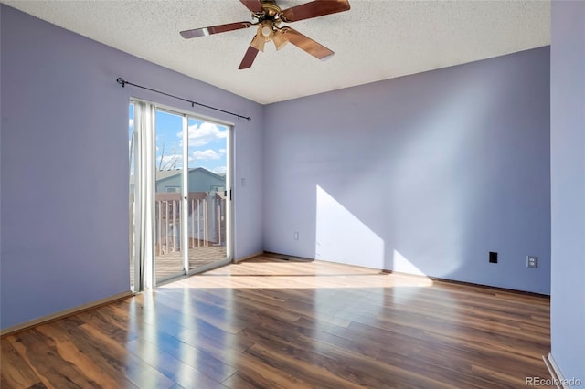 empty room featuring wood-type flooring, ceiling fan, and a textured ceiling