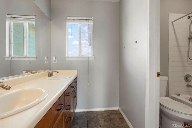 full bathroom with vanity, tiled shower / bath, and toilet