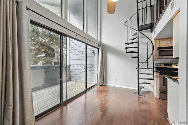 9797 E Peakview Ave Unit C10, Englewood, CO 80111 - interior space with wood finished floors, stairs, baseboards, and a high ceiling
