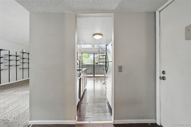 9797 E Peakview Ave Unit C10, Englewood, CO 80111 - hallway with a textured ceiling, a textured wall, and baseboards