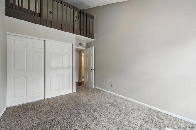 9797 E Peakview Ave Unit C10, Englewood, CO 80111 - unfurnished bedroom with carpet flooring, baseboards, a closet, and a high ceiling