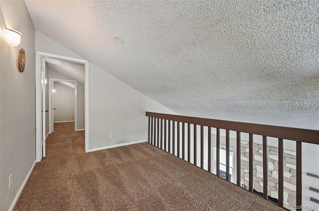 9797 E Peakview Ave Unit C10, Englewood, CO 80111 - corridor featuring a textured ceiling, carpet flooring, lofted ceiling, and baseboards