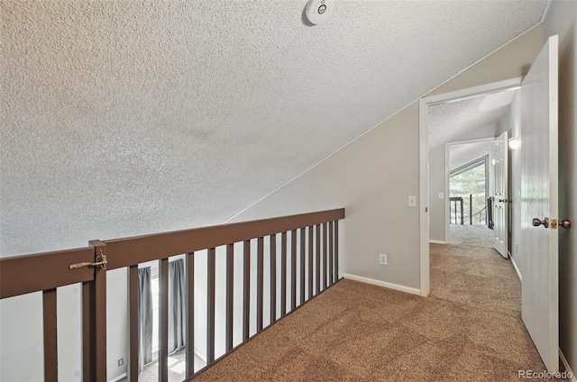 9797 E Peakview Ave Unit C10, Englewood, CO 80111 - corridor with a textured ceiling, vaulted ceiling, carpet, and baseboards