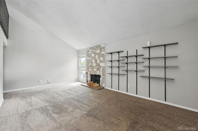 9797 E Peakview Ave Unit C10, Englewood, CO 80111 - unfurnished living room with a textured ceiling, carpet flooring, a fireplace, and vaulted ceiling