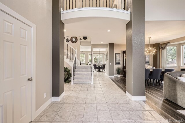 12693 W 82nd Ln, Arvada, CO 80005 - entryway with a chandelier, stairway, plenty of natural light, and baseboards
