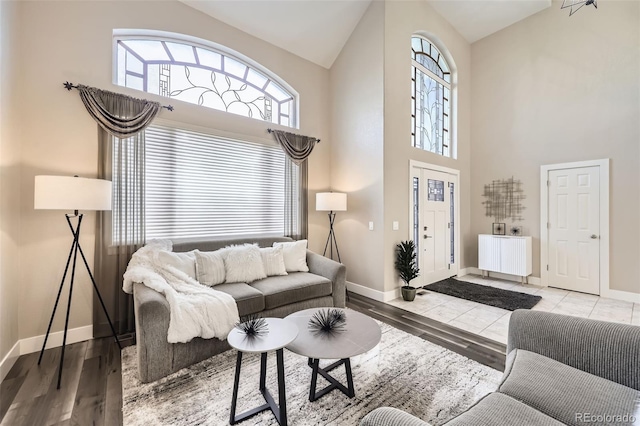 12693 W 82nd Ln, Arvada, CO 80005 - living area with high vaulted ceiling, baseboards, and plenty of natural light