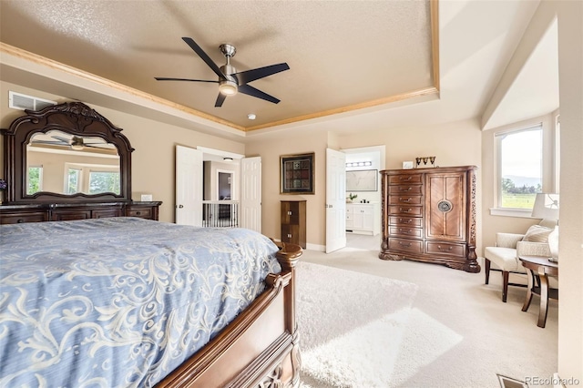 12693 W 82nd Ln, Arvada, CO 80005 - carpeted bedroom with a raised ceiling, multiple windows, ensuite bathroom, and a ceiling fan