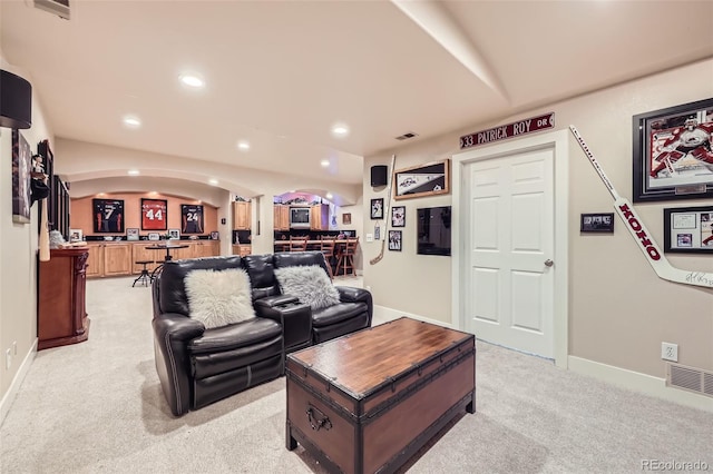 12693 W 82nd Ln, Arvada, CO 80005 - living room with arched walkways, light colored carpet, recessed lighting, baseboards, and bar area