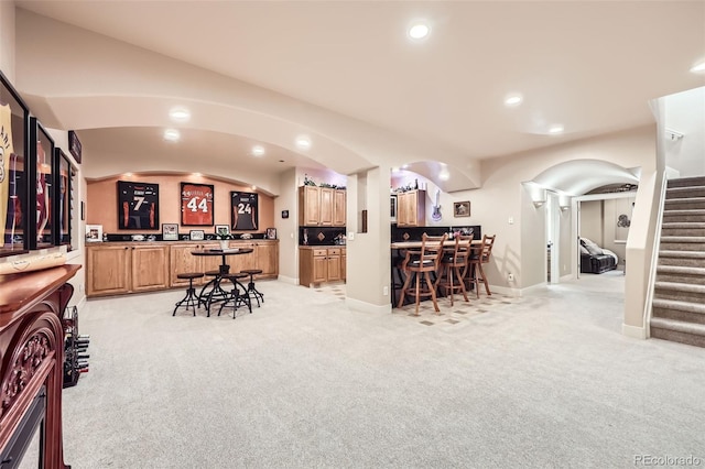12693 W 82nd Ln, Arvada, CO 80005 - kitchen featuring light carpet, recessed lighting, baseboards, lofted ceiling, and light brown cabinetry