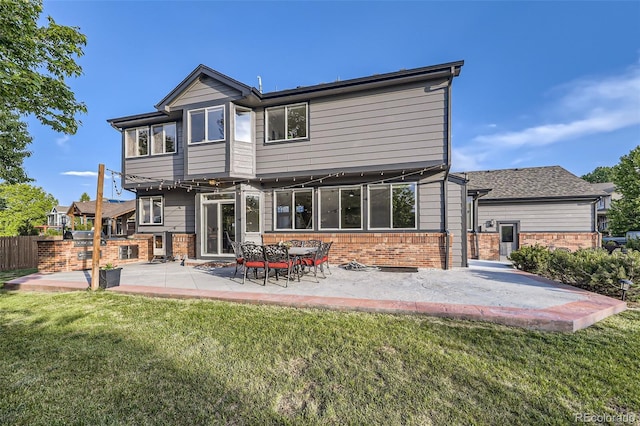 12693 W 82nd Ln, Arvada, CO 80005 - rear view of property featuring brick siding, a lawn, and a patio area