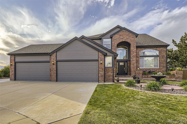 12693 W 82nd Ln, Arvada, CO 80005 - view of front of home with concrete driveway, a garage, a front lawn, brick siding, and a shingled roof
