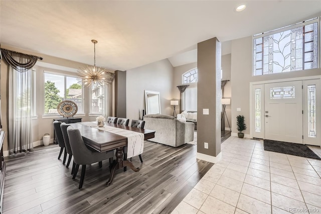 12693 W 82nd Ln, Arvada, CO 80005 - dining space featuring a chandelier, a high ceiling, recessed lighting, baseboards, and tile patterned flooring