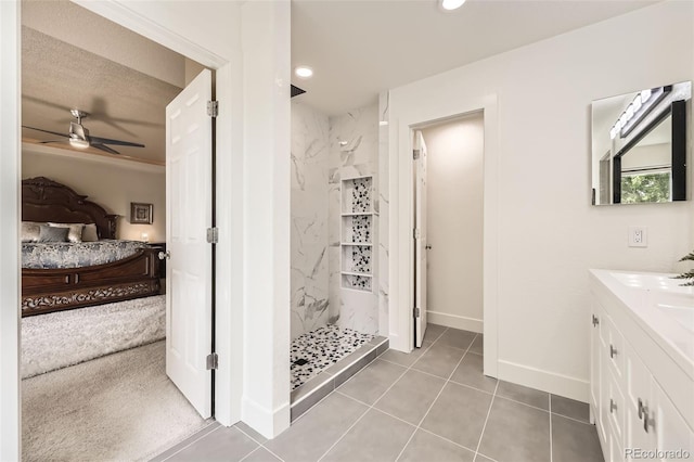 12693 W 82nd Ln, Arvada, CO 80005 - ensuite bathroom featuring a marble finish shower, a ceiling fan, vanity, tile patterned flooring, and baseboards