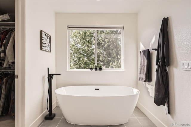 12693 W 82nd Ln, Arvada, CO 80005 - full bath featuring a freestanding tub, a spacious closet, and tile patterned flooring
