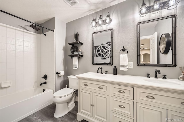 12693 W 82nd Ln, Arvada, CO 80005 - full bath with double vanity, shower / bath combination, toilet, and wood finished floors