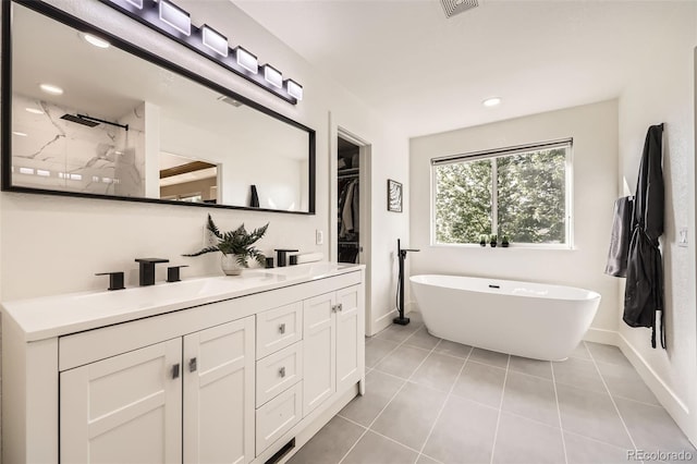 12693 W 82nd Ln, Arvada, CO 80005 - full bath featuring double vanity, tile patterned flooring, walk in shower, a freestanding bath, and recessed lighting