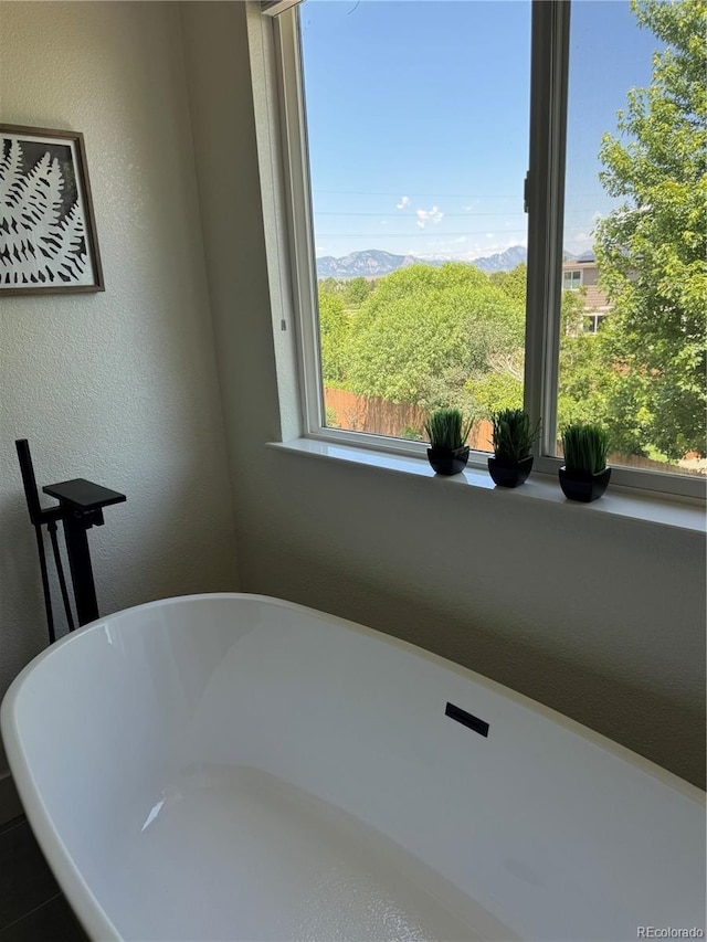 12693 W 82nd Ln, Arvada, CO 80005 - bathroom featuring a soaking tub and a textured wall