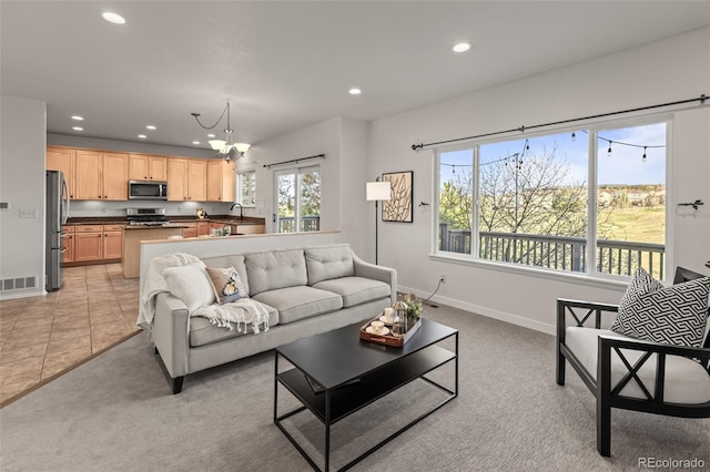 3182 Cimarron Pl, Superior, CO 80027 - living room featuring visible vents, recessed lighting, light carpet, a notable chandelier, and baseboards