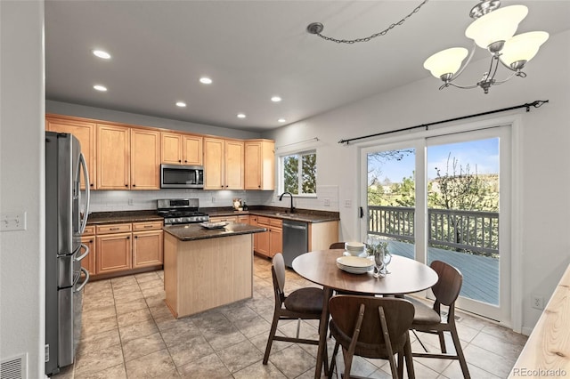 3182 Cimarron Pl, Superior, CO 80027 - kitchen featuring tasteful backsplash, a notable chandelier, a kitchen island, dark countertops, and stainless steel appliances
