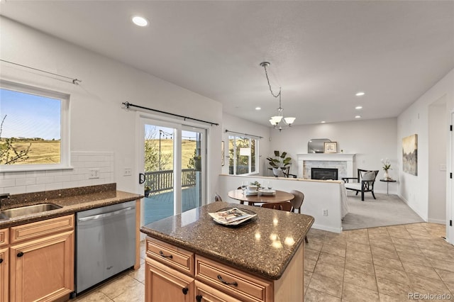 3182 Cimarron Pl, Superior, CO 80027 - kitchen featuring stainless steel dishwasher, a fireplace, open floor plan, and dark stone countertops