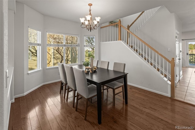 3182 Cimarron Pl, Superior, CO 80027 - dining space with baseboards, an inviting chandelier, wood finished floors, and stairs