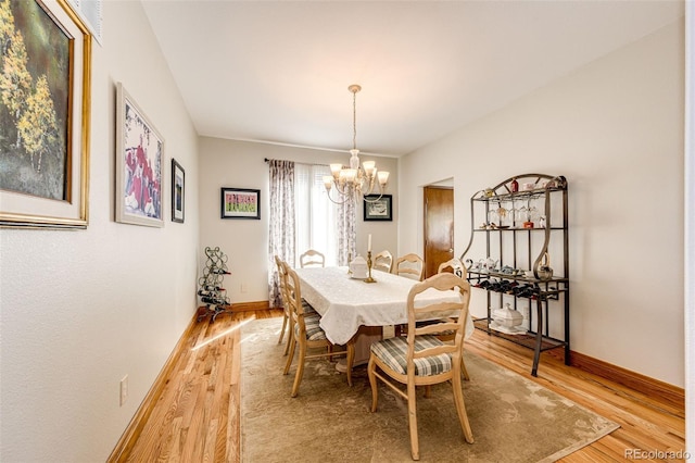 1820 Sapling Ct, Castle Rock, CO 80109 - dining room with a chandelier, light wood-style floors, and baseboards