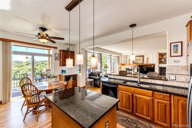 1820 Sapling Ct, Castle Rock, CO 80109 - kitchen featuring a sink, open floor plan, ceiling fan, light wood-type flooring, and dishwasher