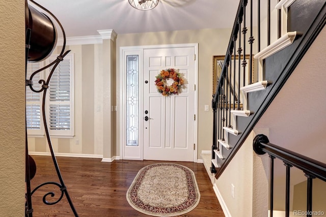 entrance foyer featuring ornamental molding and dark wood-type flooring