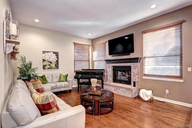 living room with hardwood / wood-style flooring and a fireplace