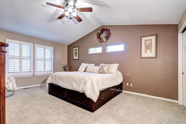 carpeted bedroom featuring multiple windows, vaulted ceiling, and ceiling fan