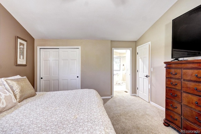 bedroom featuring light carpet, connected bathroom, and a closet