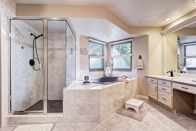 bathroom with independent shower and bath, vanity, and tile patterned flooring