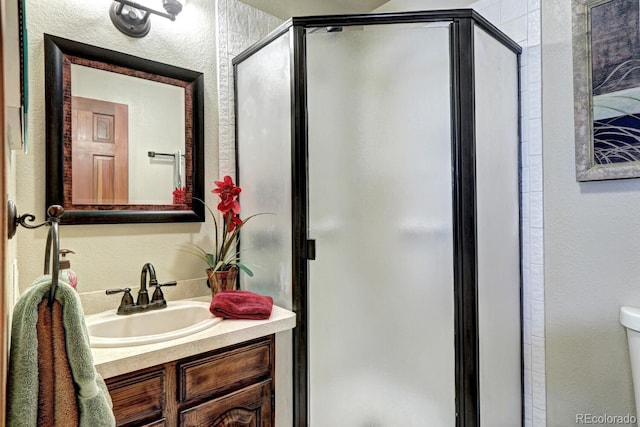 bathroom with vanity, toilet, and walk in shower